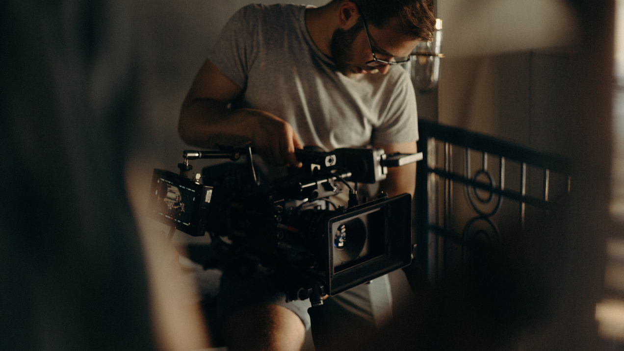 Man In Gray Crew-neck T-shirt Holding A Camera